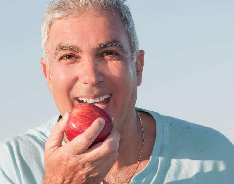 man with crowns eating an apple in wilmington