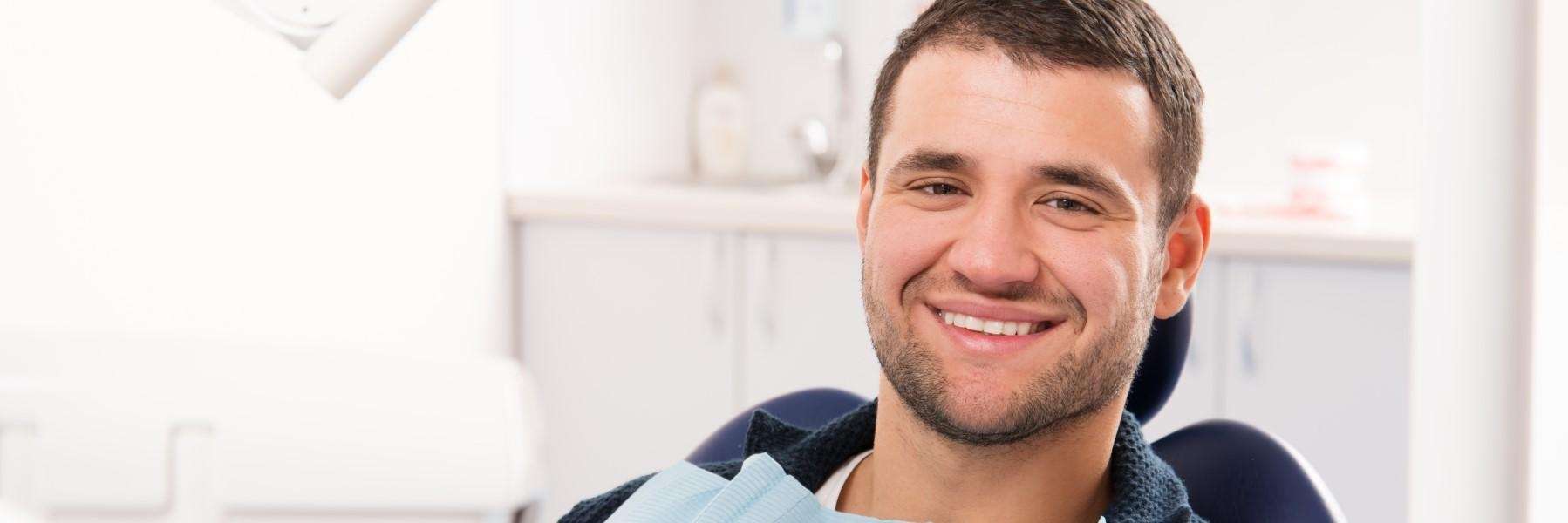 man sitting in a dental exam chair in wilmington ma